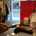 Hands making contactless payment during holiday shopping season